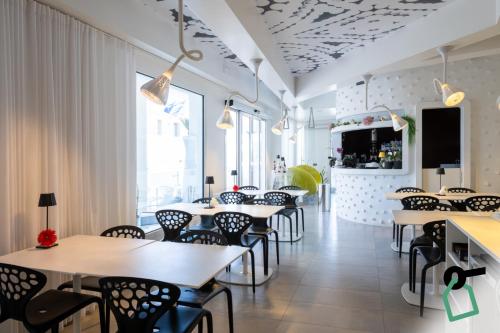 a row of tables and chairs in a restaurant at Hotiday Porto Cesareo Laguna in Porto Cesareo