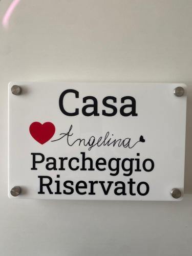 a sign on a wall with the words casa imperina imperina papaya at Casa Angelina -Humanitas- Forum Assago-private Parking in Rozzano