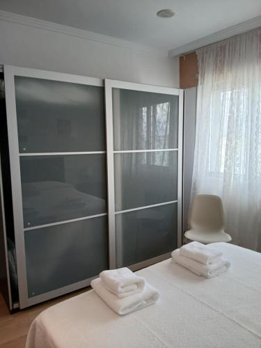 a bedroom with a bed with two towels on it at Cecilia in Muros