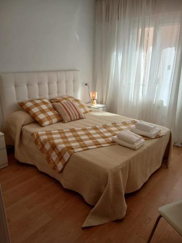 a bedroom with a large bed with two towels on it at Cecilia in Muros