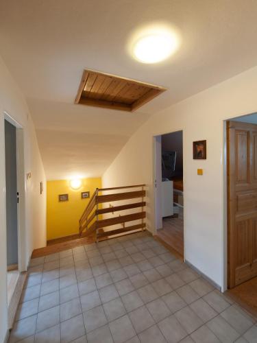 a hallway with a staircase in a house at Czech Family Home in Český Krumlov
