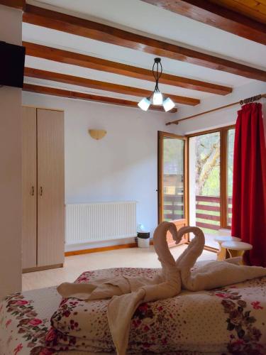 a room with a bed with two swans on it at Casa Silvia in Gârda de Sus