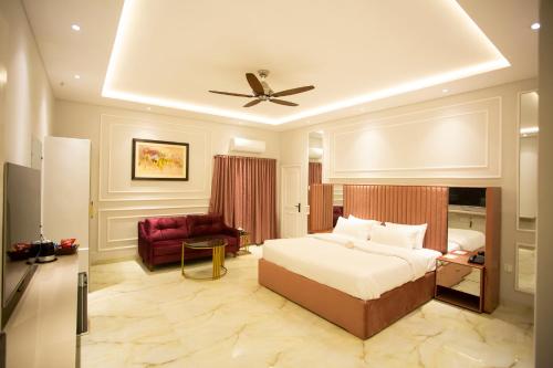 a bedroom with a bed and a ceiling fan at The Edition Signature in Bahawalpur