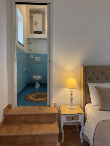 a bedroom with a bed and a bathroom with a toilet at Villa Rosmary in Massa Lubrense