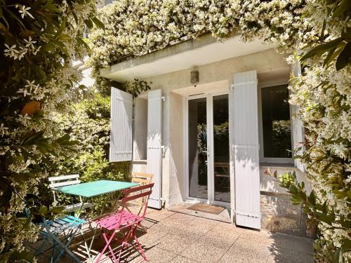 a patio with a table and chairs in front of a house at Villa Etoile in Cannes