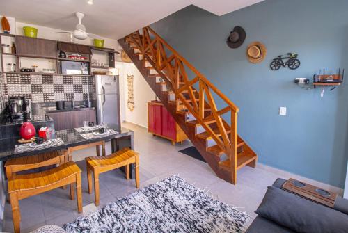 a kitchen and living room with a spiral staircase at Apto Novo Duplex em Juqhey in Juquei