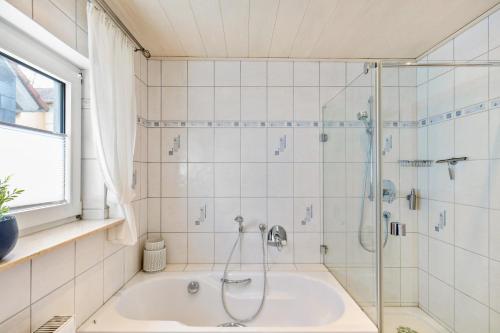 a bathroom with a shower and a tub at Zipper Burgblick Otzberg Odenwald in Hering
