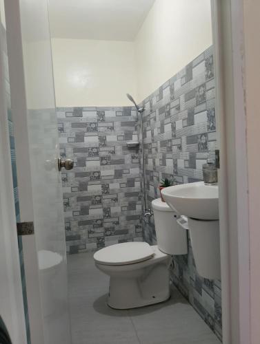 a bathroom with a toilet and a sink at Zoldyck Villa 1 in Bacolod