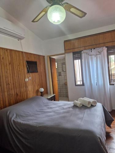 a bedroom with a large bed with two towels on it at Residencial Garcia in Embalse