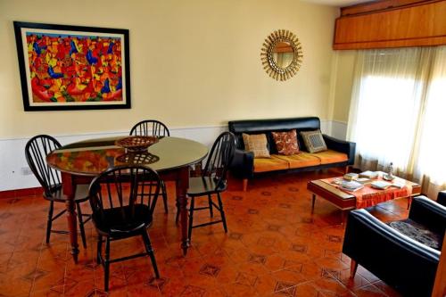 a living room with a table and a couch at Residencial Garcia in Embalse
