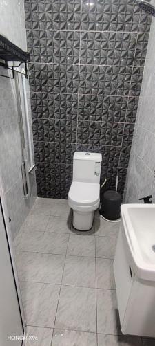a bathroom with a toilet and a sink at ZIRA STAY PENARIK - Nuha Room in Kampong Ru Sepuloh