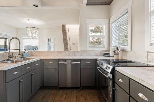 a kitchen with gray cabinets and a sink at Captain's Quarters in Smithville