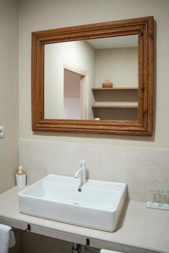 a bathroom with a white sink and a mirror at Planazo House in Arnuero