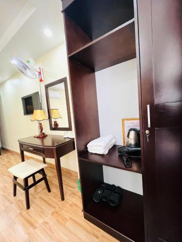 a room with a desk and a book shelf and a table at Sapa Tom's Hotel in Sapa