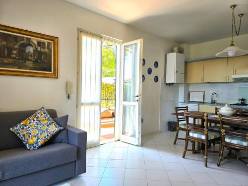 a living room with a couch and a table and a kitchen at Casa Limone by Affitti Brevi Liguria in Borgio Verezzi