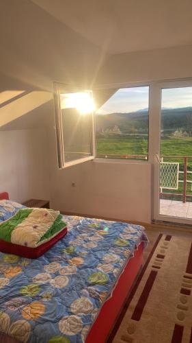 a bedroom with a bed in a room with a window at Vrba in Gacko