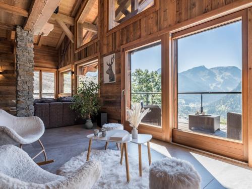 a living room with a large window with a view at Chalet Familial Le Whymper 5 étoiles SPA Sauna Chatel in Châtel