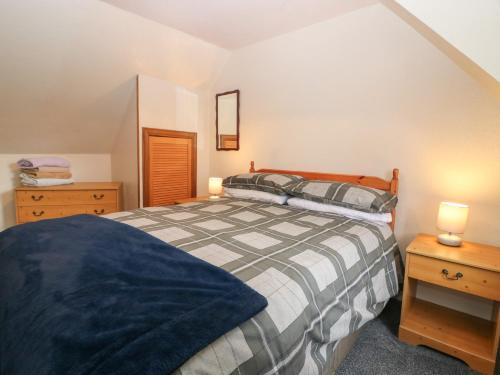 a bedroom with a bed and two night stands at Alt na Voir in Tomintoul