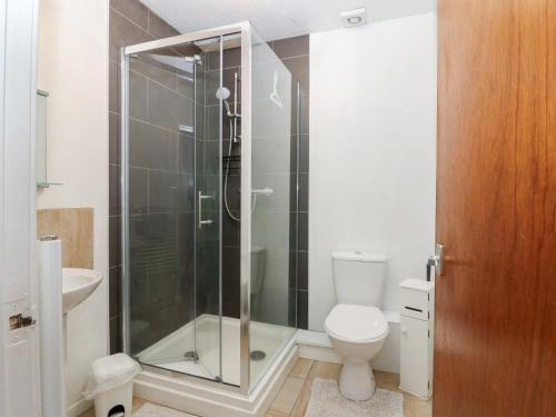 a bathroom with a toilet and a glass shower at Alt na Voir in Tomintoul