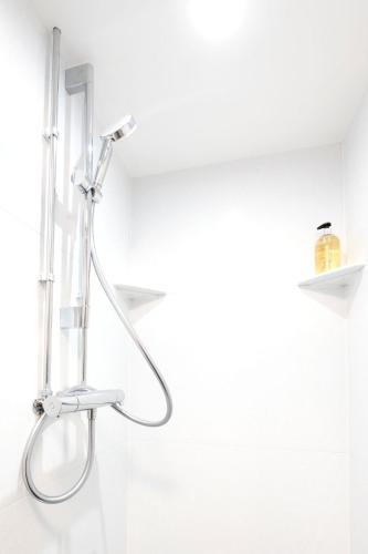 a shower head in a bathroom with white walls at Guest Rooms at Lancaster University in Lancaster