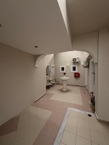 a hallway of a hospital with a sink and a toilet at Rooms By Lignou in Fira