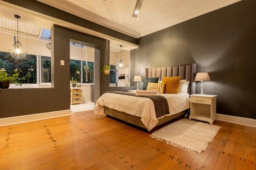 a bedroom with a large bed with yellow pillows at Lagoon Views in Knysna