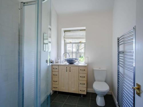 a bathroom with a sink and a toilet and a window at 1 Bed in Hexham oc-82472 in Hexham