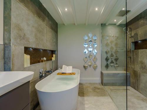 a bathroom with a tub and a shower and a sink at 1 Bed in Richmond oc-88588 in Easby