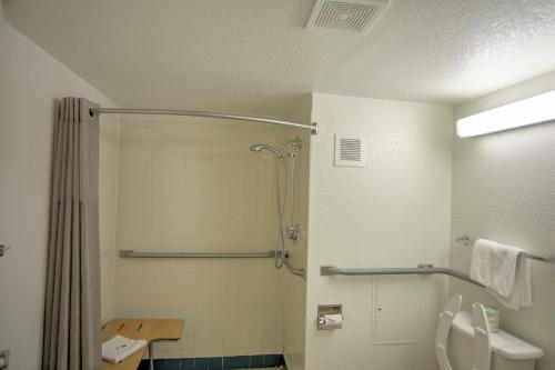 a bathroom with a shower and a toilet and a sink at Motel 6-Council Bluffs, IA - Omaha East in Council Bluffs