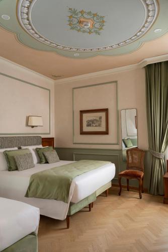 a bedroom with two beds and a circular ceiling at Adler Cavalieri Hotel-Private Spa & Gym in Florence