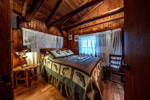 a bedroom with a bed in a wooden room at Log Cabin in Helen