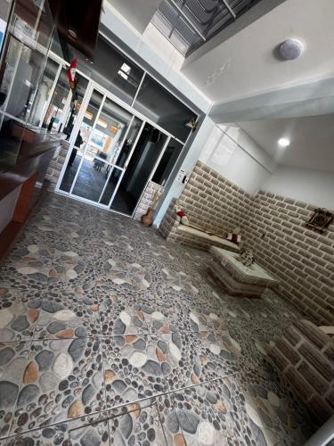 a bathroom with a tiled floor with a sink at Asian House in Uyuni