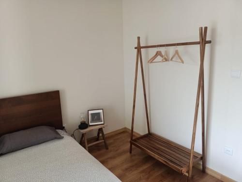 a bedroom with a bed and a wooden swing at Casa da Fraga in Alfândega da Fé