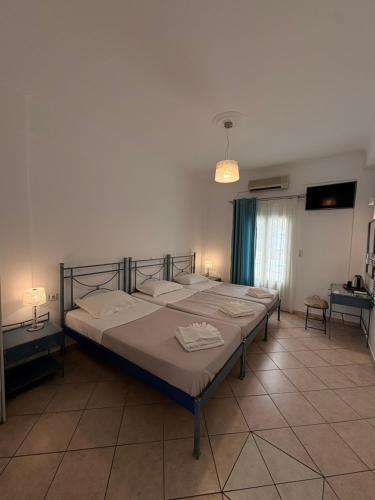 a bedroom with a large bed in a room at Rooms By Lignou in Fira