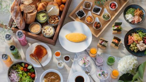 a table with many different plates of food on it at ANA Crowne Plaza Sapporo by IHG in Sapporo