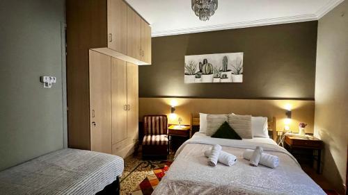 a bedroom with two beds with towels on them at Studio close to Train Station in Larisa