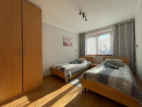a bedroom with two beds and a window at Apartmán Stráne in Martin