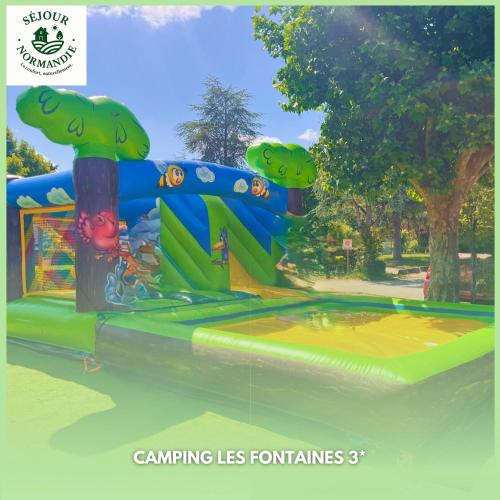 a inflatable water park with a water slide at Séjour Normandie - Mobilhome confort 2ch-4p avec clim dans l'Eure - 141 in Ivry-la-Bataille
