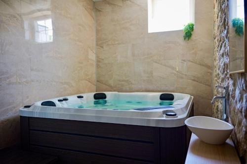 a bath tub in a bathroom with at La maison des Bretzels GÎTE Jacuzzi privé illimité in Pfaffenhoffen