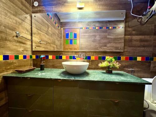 a bathroom with a sink and a bowl on a counter at Eternal Bliss By Ganga Blessing in Rishīkesh