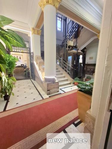 a lobby with a staircase in a building at New Palace in Cairo
