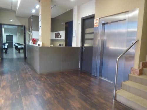 an office lobby with stairs and an elevator at Hotel Pere III El Gran in Vilafranca del Penedès