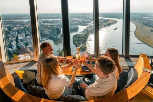 a group of people sitting at a table with wine glasses at Crowne Plaza Düsseldorf - Neuss by IHG in Neuss