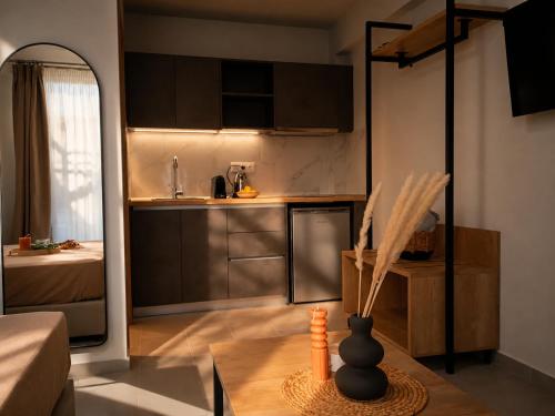 a kitchen with brown cabinets and a vase on a table at AISTHISIS Suites in Ierissos
