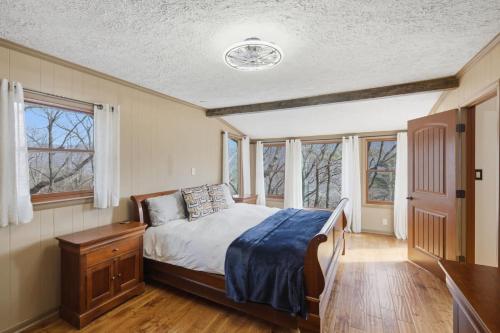 a bedroom with a bed and some windows at Vista Ridge at Alpine 4BDR in Jasper