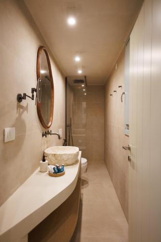 a bathroom with a sink and a mirror at Eos Milos House in Pollonia