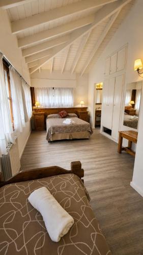 a large room with two beds in a room at Mojomar Pinamar Hotel in Pinamar