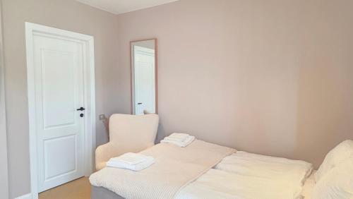 a bedroom with a bed and a mirror and a chair at Your home away from home 3 in Floreşti