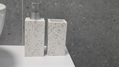 two white vases sitting next to a toilet at Your home away from home 3 in Floreşti