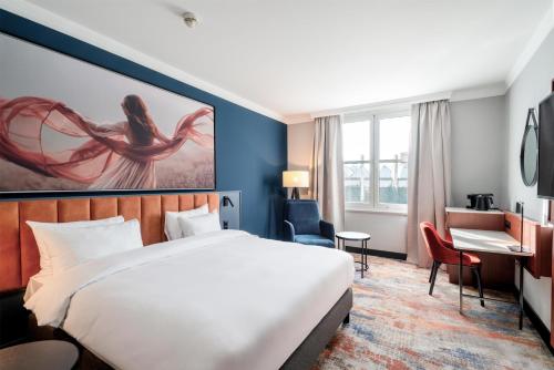 a hotel room with a bed and a desk at Radisson Blu Hotel Wroclaw in Wrocław
